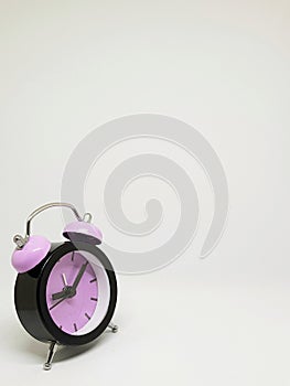 Pink alarm clock with white background photo