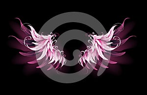 Pink angel wings on black background
