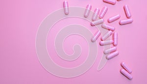 Pink antibiotic capsule pills spread on pink background. Antibiotic drug resistance. Pharmaceutical industry. Healthcare and