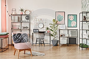 Pink armchair in workspace interior