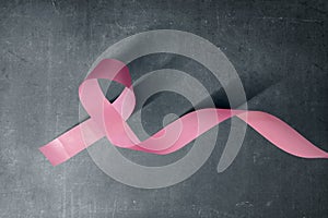 Pink awareness ribbon on a black background