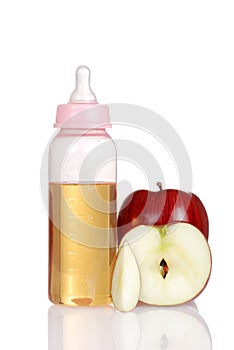 Pink baby bottle with fresh apple juice