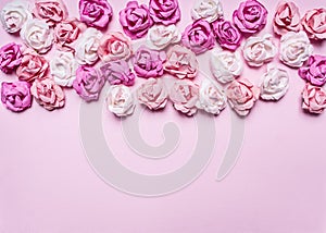 Pink background with colorful paper roses decorations Valentine's Day border ,place text top view close up