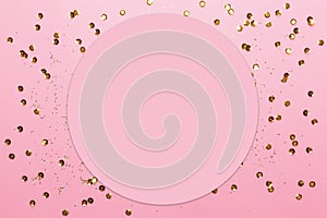 Pink background with gold sequins and shining paillettes with copy space. Greeting card. Mock up