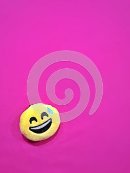 Pink background with a smiling icon
