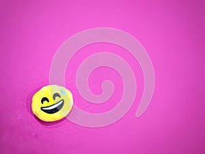 Pink background with a smiling icon