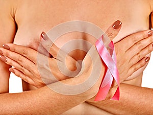 Pink badge on woman finger to support breast