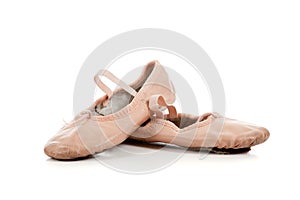 Pink ballet slippers on white