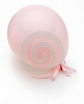 Pink balloon with delicate white bows. Isolated on white background