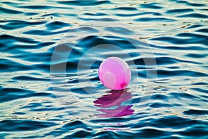 Pink Balloon Drifting At Sea