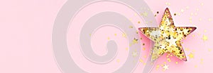 Pink banner.Festive flatly. Star made of cookie form and golden confetti at pastel pink background. Creative decoration