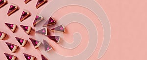 pink banner with lot of chocolate cake slices. Minimal composition of tart pieces. sweet dessert