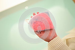 pink bath bomb on woman hand, relaxation time