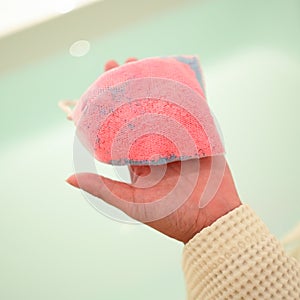 pink bath bomb on woman hand, relaxation time