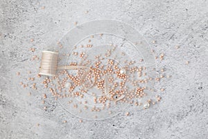 Pink  beads scattered on a marble background close up