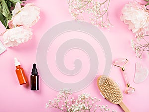 Pink beauty floral frame background with bottles