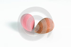 Pink beauty tear-shaped blender, dirty and clean sponges isolated on white background. Cosmetic tool for makeup in hand.