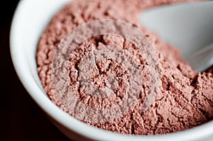 Pink bentonite clay powder in the onyx bowl. Diy facial mask and body wrap recipe. Natural beauty treatment and spa. photo