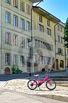 Pink bicycle in the historic district of Fribourg Freiburg, Switzerland