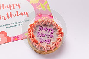 Pink birthday cookie with a birthday card