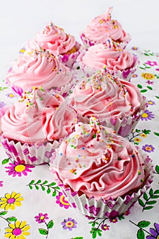 Pink birthday cupcakes with whipped cream