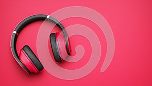 Pink and black wireless headphones isolated on pink