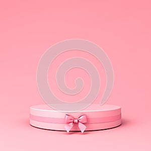 Pink blank round podium pedestal with pink pastel color ribbon bow on light pink background