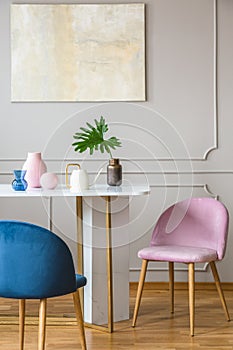 Pink and blue armchair in the pastel dining room interior