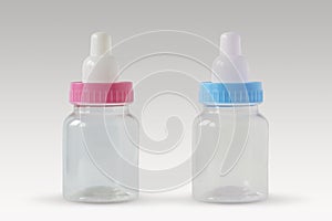 Pink and blue baby bottles - Male or female? Concept of future baby gender