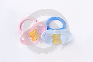 Pink and blue baby silicone pacifiers.