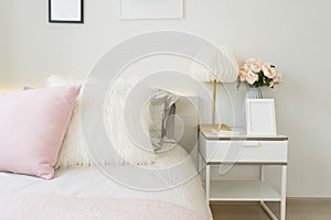 Pink and blue blanket with creative pillows on bed in colorful kids room