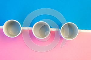 Pink and blue coffee cups on coloured background ,graphic image with bright colours