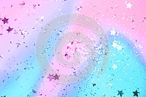 Pink and blue confetti and stars and sparkles on pink background