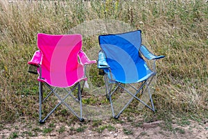 Pink and blue folding camping chairs