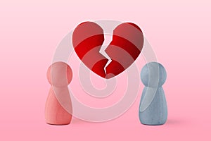 Pink and blue pawn with broken heart - Concept of love ending and divorce