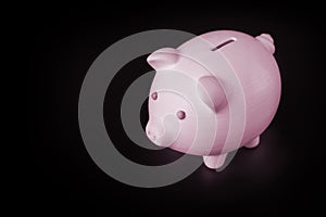 Pink blue piggy bank on a black background with place for text, copy space. Concept for 3D printing from plastic.
