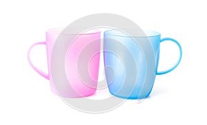Pink and blue plastic cups on white background