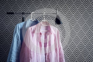 Pink and blue shirts on wallpaper background