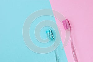 Pink and blue toothbrushes for him and her, minimal design, copy space
