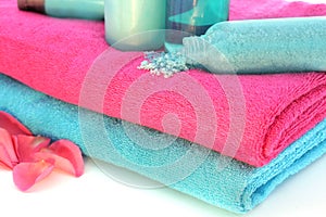 Pink and blue towels with shampoo, solt......