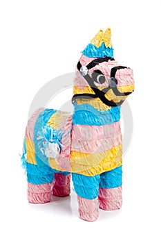 Pink, blue and yellow burro pinata on white