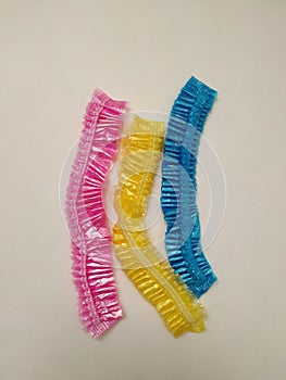 pink, blue and yellow disposable shower caps.
