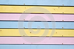 Pink blue and yellow pastel coloured wooden slats