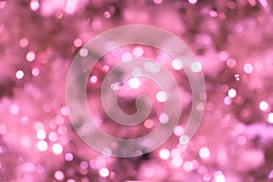 Pink blurred background with bokeh lights/closeup of blurred pink Christmas tree with lights