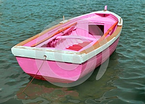 Pink boat in the middle of the ocean