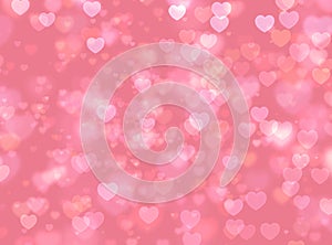 Pink  bokeh hearts on blurred background.