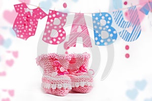 Pink bootees and baby word garland
