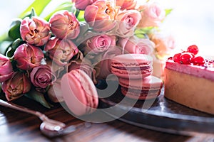 Pink bouquet of flowers and sweet delicacies