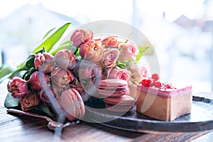 Pink bouquet of flowers and sweet delicacies