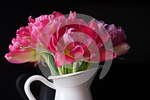 pink bouquet flowers white vase black background tulips